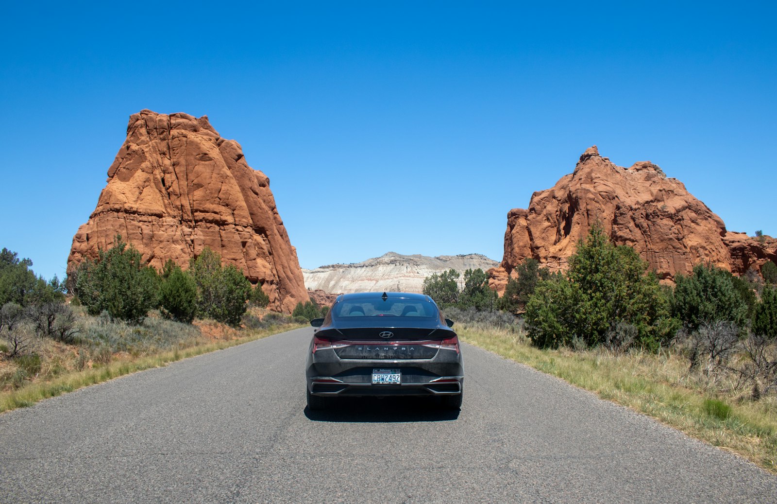 A car driving down a road in the desert